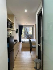 a kitchen with a refrigerator and a dining room at The Ló Apartment in Kon Rung (1)