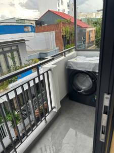 a washing machine is sitting on a balcony at The Ló Apartment in Kon Rung (1)