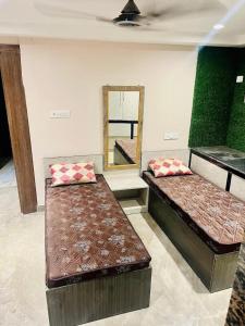two beds sitting in a room with a mirror at Nestup Stay for Boys in New Town +15 photos