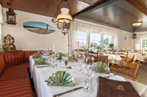 a dining room with tables with white tablecloths at Hotel-Restaurant Faehr-Cafe in Niesgrau