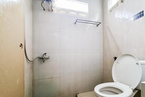 a small bathroom with a toilet and a shower at RedDoorz near Gajah Mada Park Medan in Medan +26 photos