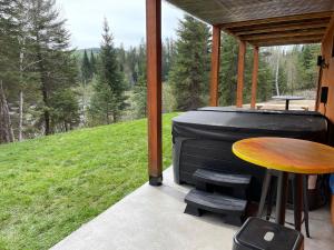 een afgeschermde veranda met een grill en een tafel bij Chalet L'Orée Étoilée in La Tuque +9 foto's