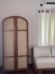 a living room with a couch and a window at Origin Balapitiya- Family Villa 200m From Beach in Balapitiya +41 photos