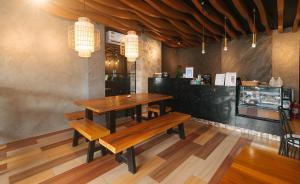 a dining room with two benches and a table at Avelida Homes by RedDoorz in Iloilo City