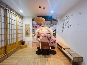 a room with a table and flowers on the wall at Milo's Home in Gò Công