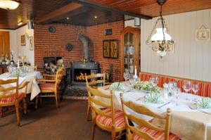 a dining room with tables and chairs and a fireplace at Hotel-Restaurant Faehr-Cafe in Niesgrau