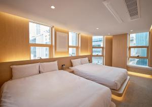- 2 lits dans une chambre d'hôtel avec fenêtres dans l'établissement UH Suite The Coex, à Séoul 36 autres photos