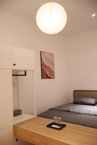 a bedroom with a bed and a table with glasses on it at GIA Hotel & Serviced Apartment in Nhơn Trạch