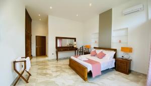 a bedroom with a bed and a desk in a room at Silva Villa Negombo in Negombo