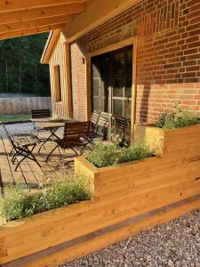 a patio with chairs and a table on a building at Tolles Ferienhaus In Altwarp Mit Garten in Altwarp