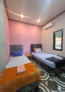 Postel nebo postele na pokoji v ubytování Mangkulio Guest House