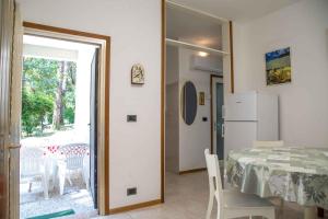 une cuisine et une salle à manger avec une table et un réfrigérateur dans l'établissement Holiday home in Eraclea Mare 25653, à Marina di Santa Croce