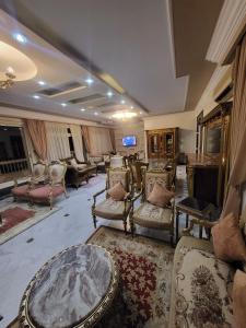 a large living room with chairs and a table at Villas with direct sea views and apartments with partial sea views in Miami, Alexandria, Al Safwa Tower, in Alexandria