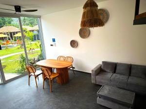 a living room with a table and a couch at Aqua Dive resort Amed in Amed