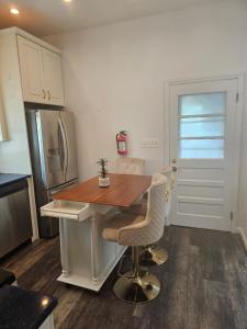 a kitchen with a wooden table and a refrigerator at Cozy Getaway 2-Penn Station,NJPAC,Prudential Center in Kearny
