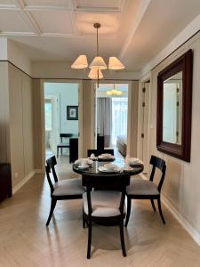 a living room with a dining room table and chairs at Rongratana Executive Residence Bangkok in Bangkok