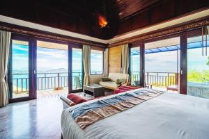a bedroom with a large bed and large windows at Sandalwood Luxury Villa Resort in Lamai +153 photos