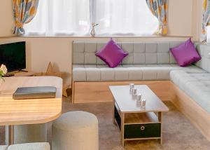 a living room with a couch and a table at Beech Hedge in Coupar Angus