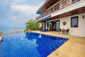 a swimming pool in front of a villa at Sandalwood Luxury Villa Resort in Lamai