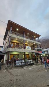 a building with picnic tables in front of it at Shivpuri House Kedarnath in Kedārnāth