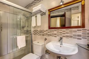 a bathroom with a toilet and a sink and a mirror at New albatros in Rome