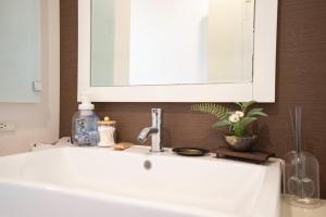 a white bathroom sink with a mirror above it at kotinoma kuu in Hakozaki +28 photos