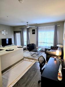 a living room with a couch and a table at Queen City Getaway with Pool in Charlotte