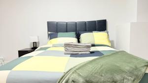 a bedroom with a large bed with towels on it at Zillion’s Bliss - Basement Suite in Calgary