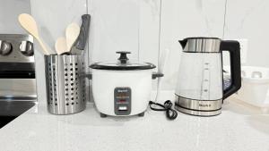 a kitchen counter with a food processor and a blender at Zillion’s Bliss - Basement Suite in Calgary