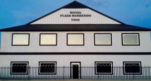a large white building with a black roof at Hotel Plaza Berrendo in Campo Menohita 307
