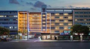 a large building with lights on in a city at Yiwu Guomao Hotel in Yiwu