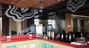 a fast food restaurant with a counter top with avertisement at Jinjiang Inn Style Taiyuan South Inner Ring North Campus Finance and Economics University in Taiyuan