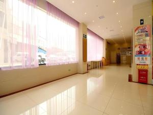 a hallway with a large window in a building at 7 Days Inn Fucheng Wu Gongci Gaodeng East Street Binjiang Road in Haikou