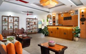 a lobby of a store with orange chairs and tables at Indra Angkor Residence in Siem Reap +82 photos