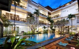 an exterior view of a hotel with a swimming pool at Indra Angkor Residence in Siem Reap