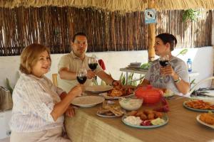 a group of people sitting at a table with wine glasses at CASA KINICH SISAL in Sisal