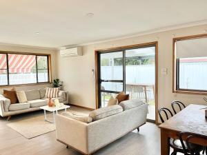 a living room with a couch and a table at Casa Al Mare- family and pet friendly, close to everything in Gold Coast