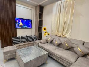 Una sala de estar con un sofá y un televisor en Monal by Shubhs, en Jāmb