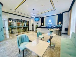 a lobby with a table and chairs in a store at Xana Lite Guiyang Huaguoyuan Shuangzi Towers in Guiyang