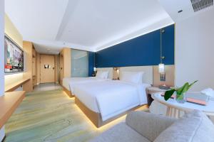 Postel nebo postele na pokoji v ubytování huameidahotel