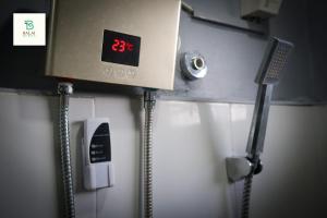 a clock on the wall of a public bathroom at Balai Berde Baguio in Baguio