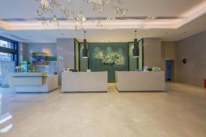 a large room with a store with counters and lights at Echarm Hotel Xinyu Railway Station Baoshi Park in Xinyu