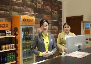 two women standing at a counter in a store at Jtour Inn Huanggang Wuxue City Square in Wuxue