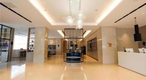 a large lobby with a chandelier in a building at Echarm Hotel Liuzhou Liunan Wanda Plaza in Liuzhou