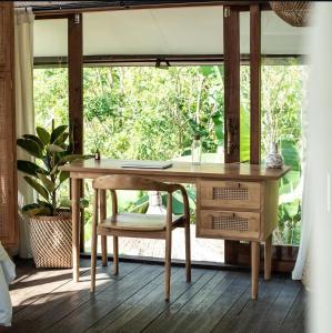 an office with a wooden desk and a chair at Light The Path Bali in Uluwatu