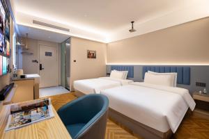 Postel nebo postele na pokoji v ubytování WJ Kaiyi Hotel + 37 fotografií