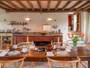 a kitchen with a wooden table with chairs and a dining room at Blaenau - Uk50400 in Llanstephan