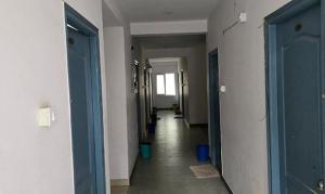 a hallway with blue doors and a long hallway with at FabHotel RK Grand in Hyderabad