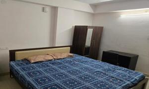 a bedroom with a bed and a television in it at FabHotel RK Grand in Hyderabad +17 photos
