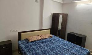 a bedroom with a bed and two pillows on it at FabHotel RK Grand in Hyderabad